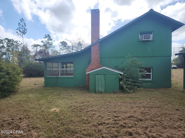 rear view of property with a lawn