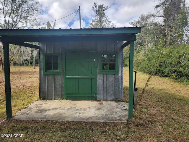 view of outbuilding with a lawn