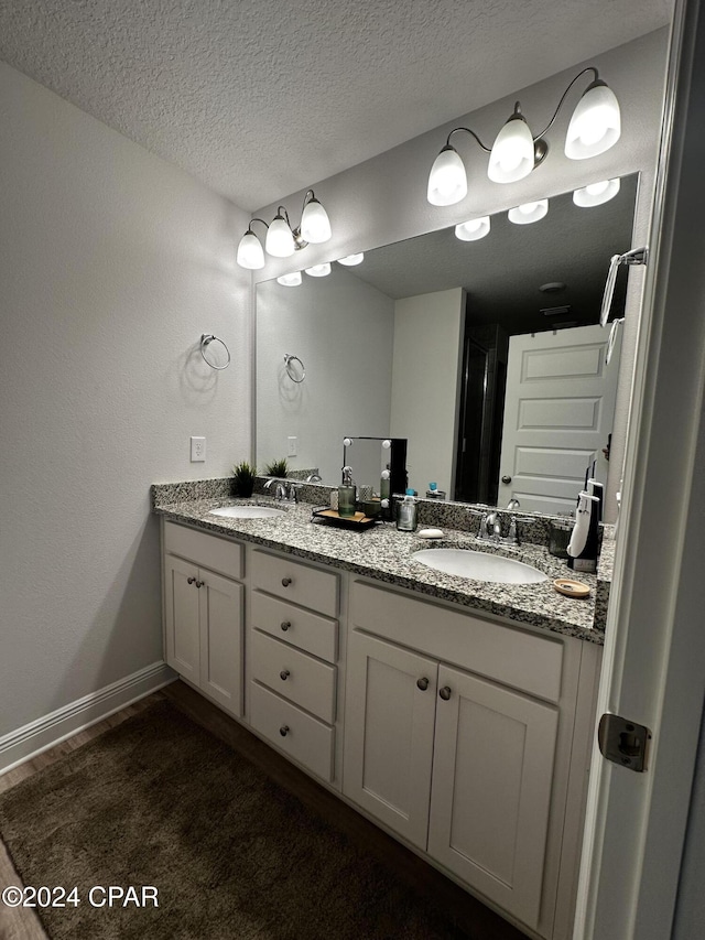 bathroom with vanity and a textured ceiling