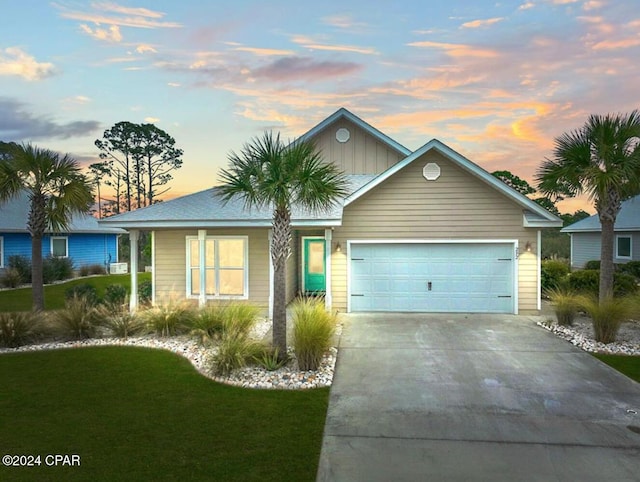 view of front of property featuring a yard and a garage