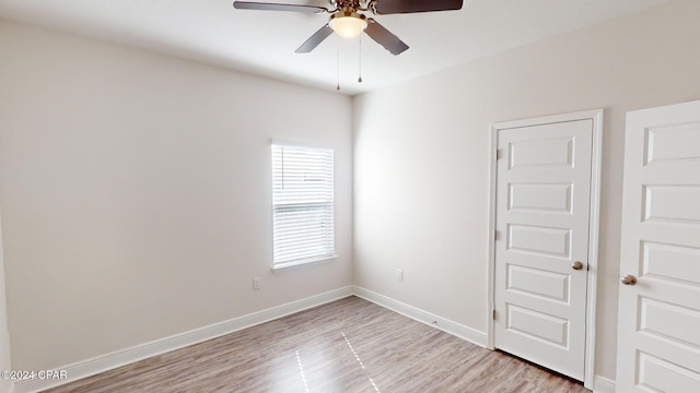 spare room with light hardwood / wood-style flooring and ceiling fan