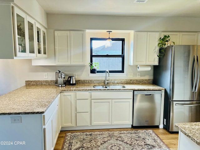 kitchen with white cabinets, sink, and stainless steel appliances