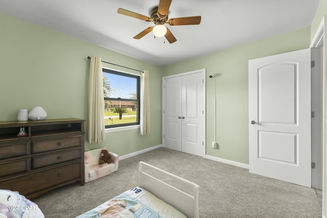 bedroom with ceiling fan, a closet, and light carpet