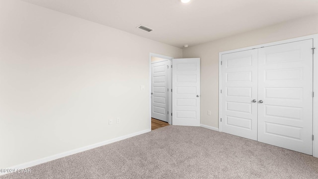 unfurnished bedroom featuring a closet and carpet