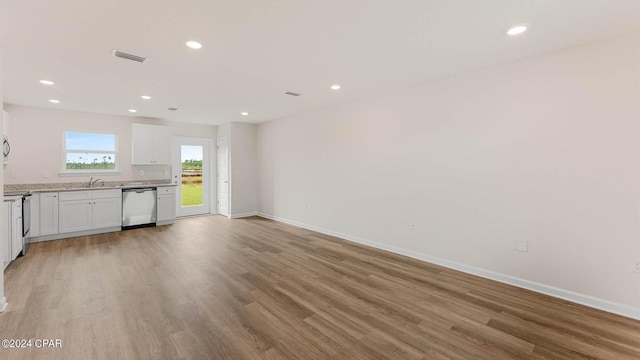 kitchen featuring light hardwood / wood-style floors, sink, stainless steel appliances, and white cabinetry