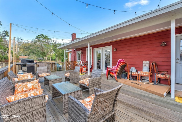 deck featuring area for grilling, french doors, and an outdoor hangout area