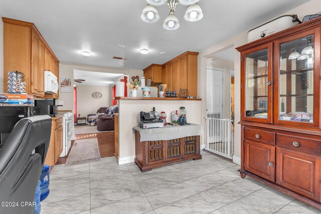 748 3rd St, Chipley, FL 32428 - kitchen with white appliances, a chandelier, light marble finish flooring, glass insert cabinets, and open floor plan