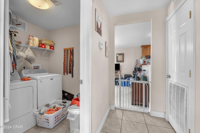748 3rd St, Chipley, FL 32428 - laundry area featuring separate washer and dryer, light tile patterned flooring, and baseboards