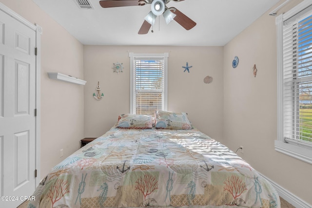 748 3rd St, Chipley, FL 32428 - bedroom featuring multiple windows and ceiling fan
