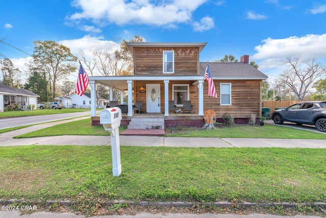 view of front of house with a porch and a front yard