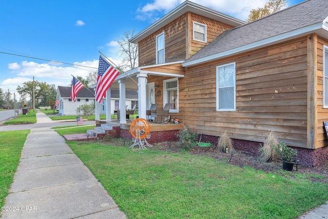 view of front facade with covered porch and a front lawn