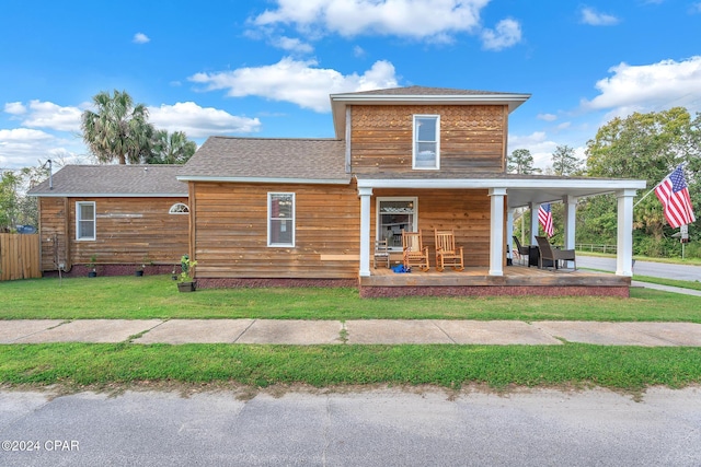 748 3rd St, Chipley, FL 32428 - back of house featuring covered porch and roof with shingles