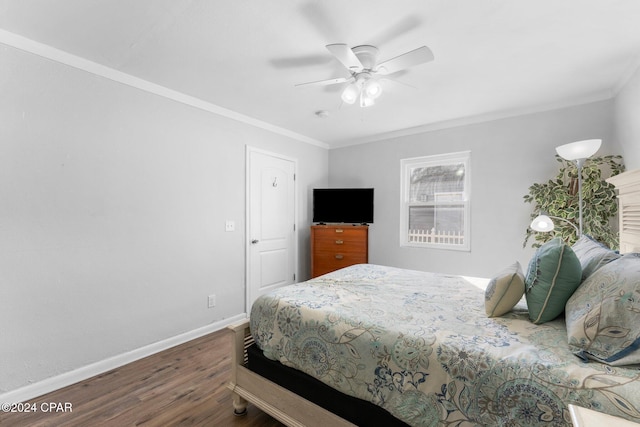 bedroom featuring ceiling fan, dark hardwood / wood-style flooring, and crown molding