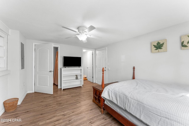 bedroom featuring electric panel, ceiling fan, and hardwood / wood-style floors