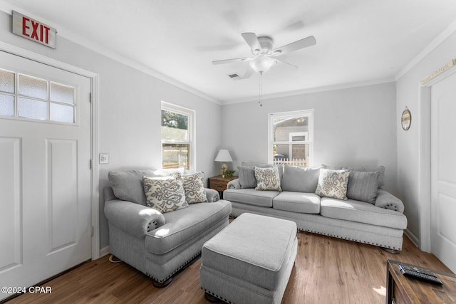 living room with wood-type flooring, ceiling fan, and ornamental molding