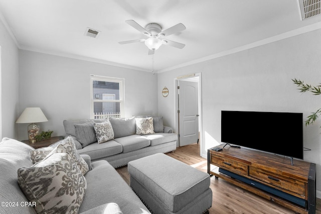 living room with hardwood / wood-style floors, ceiling fan, and ornamental molding