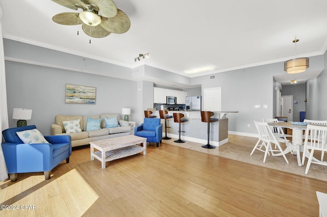 living room featuring crown molding and light wood-type flooring