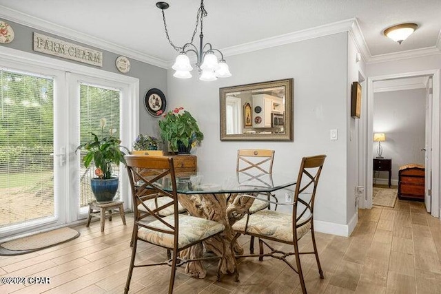 dining room with light wood-type flooring, a chandelier, and ornamental molding