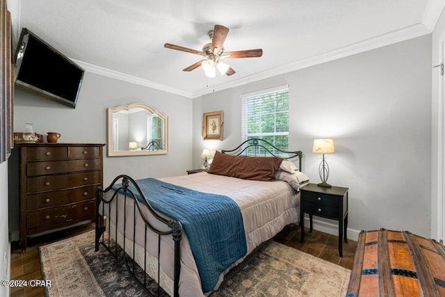 bedroom with dark hardwood / wood-style floors, ceiling fan, and ornamental molding