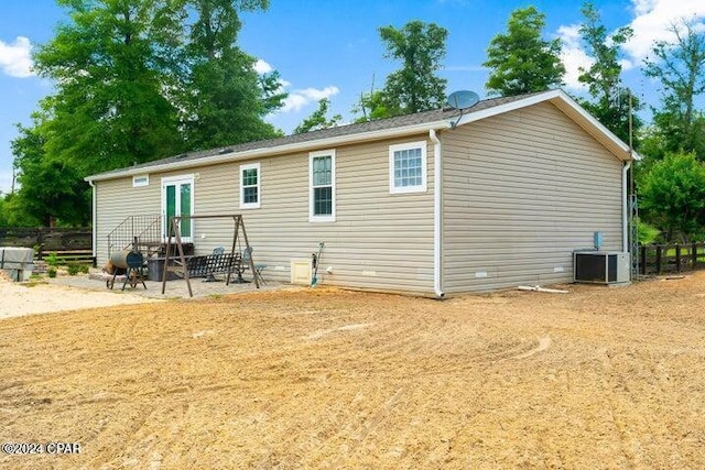 back of house with central AC unit and a patio