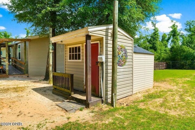 view of outbuilding featuring a lawn