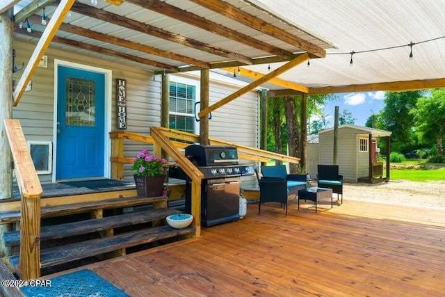 wooden deck featuring area for grilling, a storage shed, and an outdoor hangout area