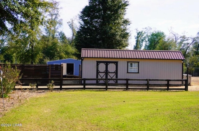 view of outbuilding with a lawn