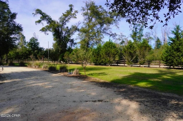 view of property's community with a yard and a rural view