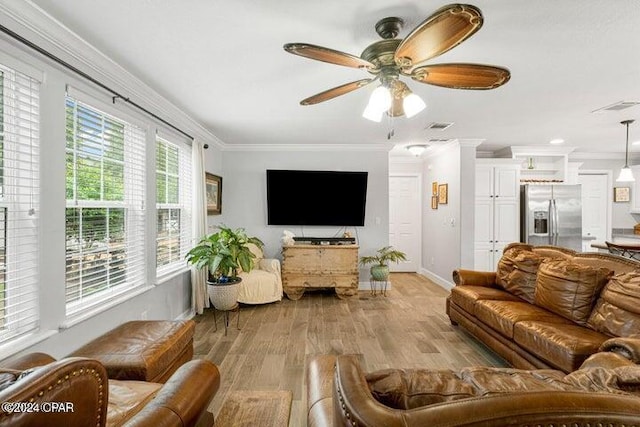 living room featuring ceiling fan, ornamental molding, and light wood-type flooring