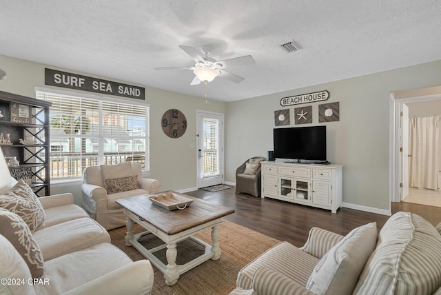 living room featuring a textured ceiling, ceiling fan, and dark hardwood / wood-style floors