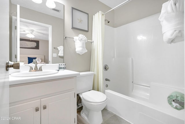 full bathroom with tile patterned floors, vanity, toilet, and shower / bath combo with shower curtain