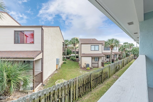 view of side of home featuring a yard and central AC