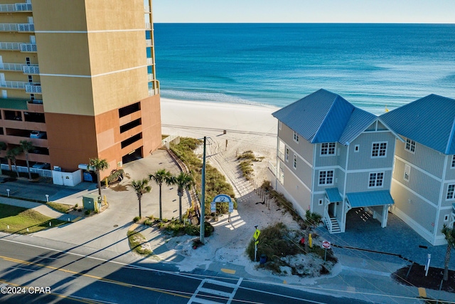 bird's eye view with a water view and a beach view