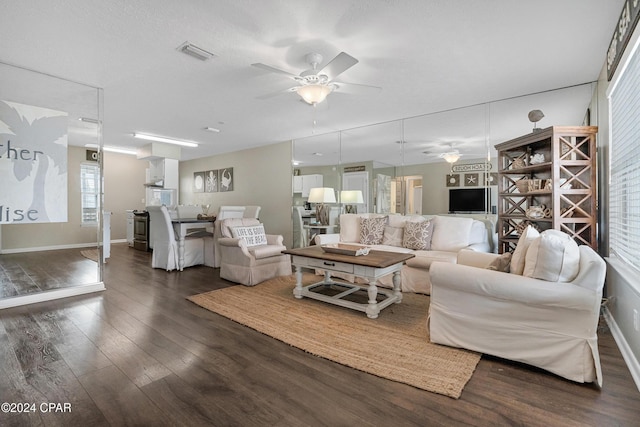 living room with ceiling fan and dark hardwood / wood-style floors