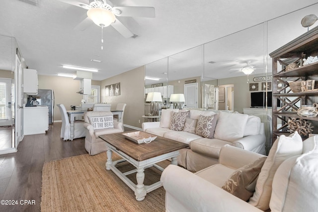 living room featuring hardwood / wood-style flooring and ceiling fan