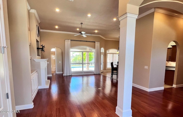 interior space with ornate columns, ceiling fan, dark hardwood / wood-style floors, and ornamental molding