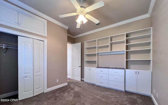 unfurnished bedroom featuring a closet, dark carpet, ceiling fan, and ornamental molding