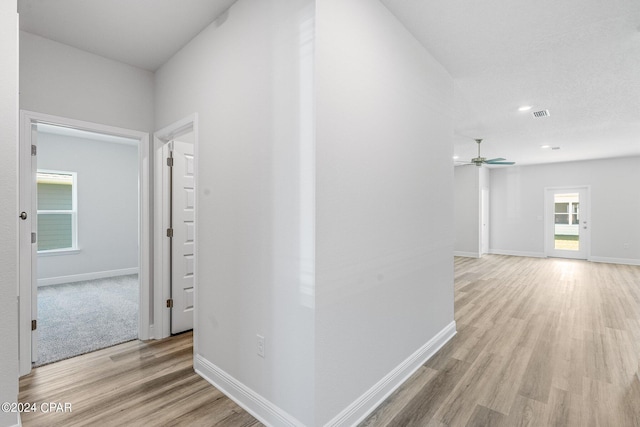 corridor with light wood-type flooring