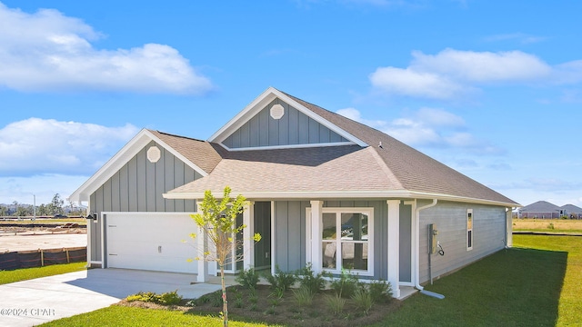 view of front of house with roof with shingles, a front lawn, concrete driveway, a garage, and board and batten siding