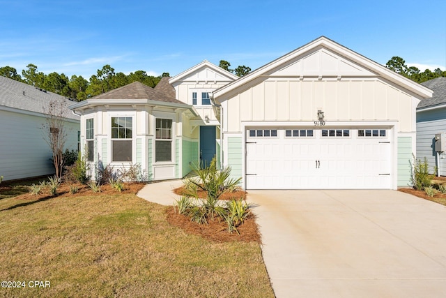 view of front facade with a garage and a front lawn