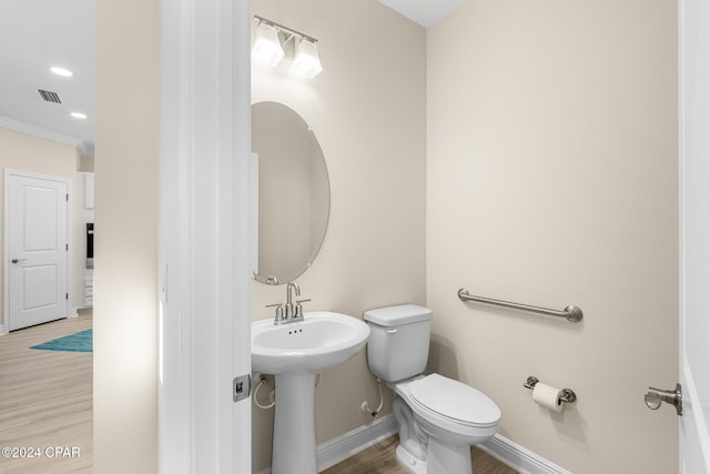 half bathroom featuring wood finished floors, visible vents, baseboards, recessed lighting, and toilet