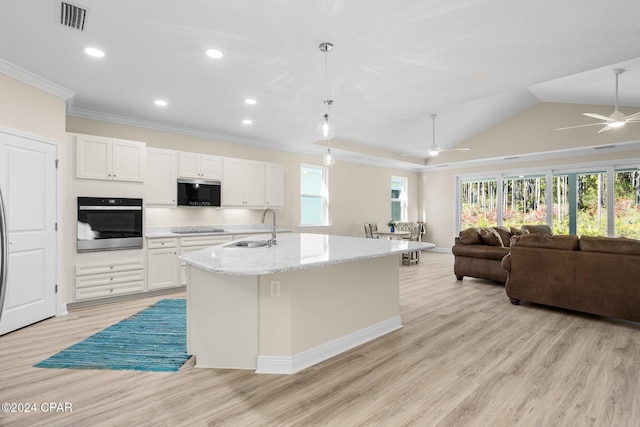 kitchen with ceiling fan, visible vents, a sink, ornamental molding, and stainless steel appliances
