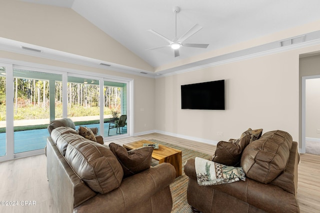 living area with light wood-style flooring, visible vents, and vaulted ceiling