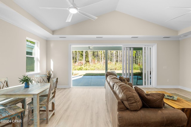 living room featuring light wood-style floors, a ceiling fan, and vaulted ceiling