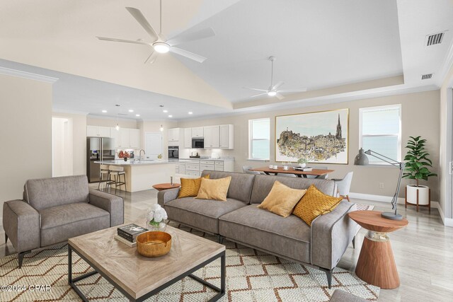 living room featuring ceiling fan, plenty of natural light, and visible vents