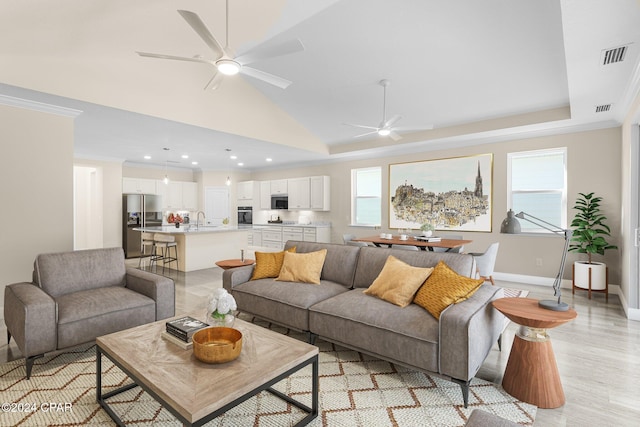 living room featuring plenty of natural light, visible vents, and ceiling fan