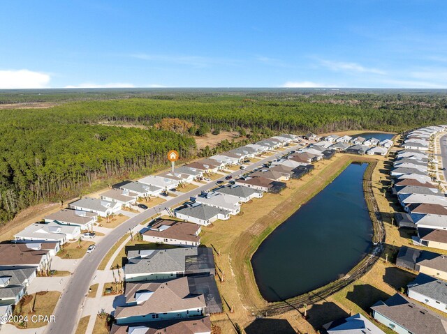 aerial view with a water view, a residential view, and a view of trees