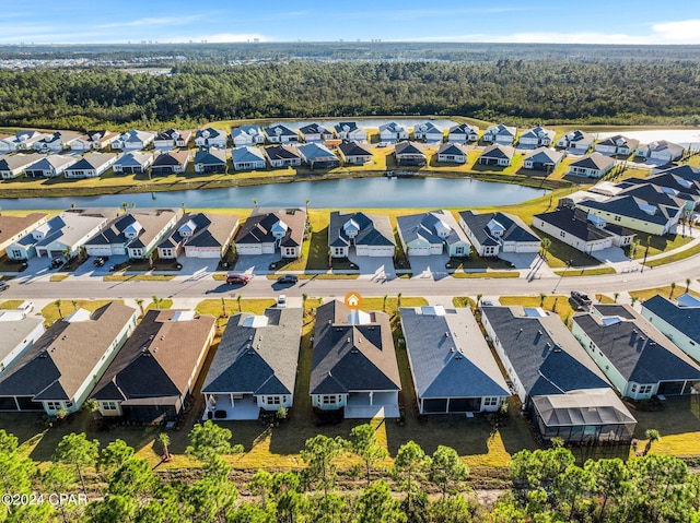 drone / aerial view with a water view and a residential view