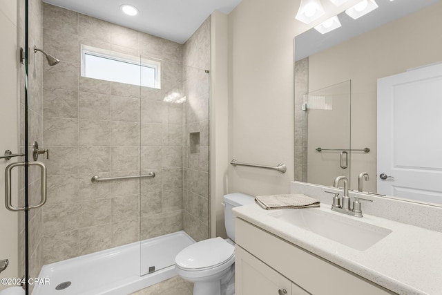 full bathroom featuring vanity, a shower stall, and toilet