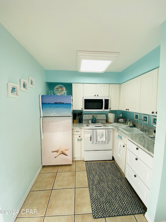 kitchen featuring white cabinetry, white appliances, sink, and light tile patterned floors